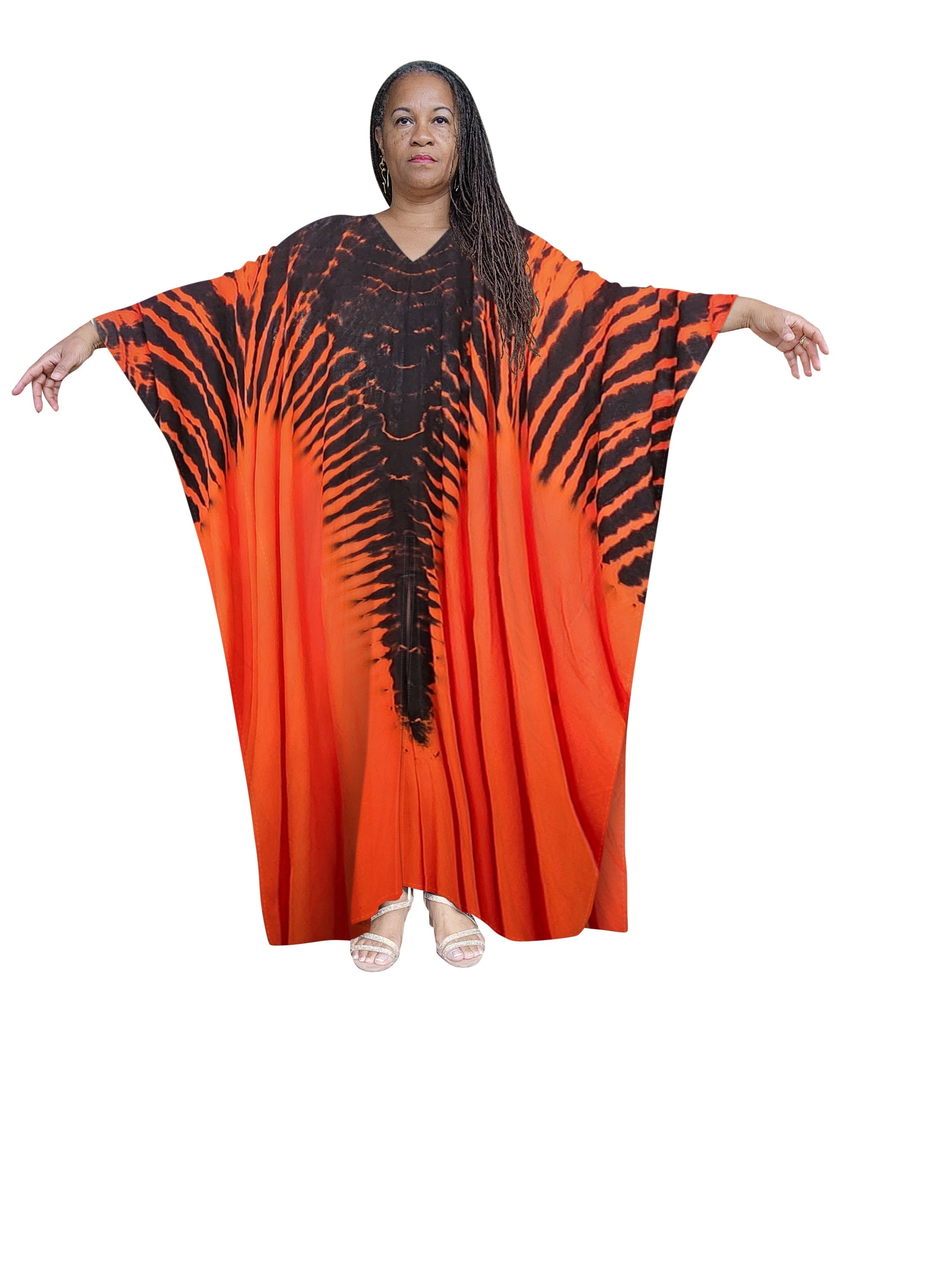 Vibrant hand-dyed kaftan maxi dress in orange and black with a striking pattern. A bold and stylish choice for Memorial Day 2024 and summer fashion.