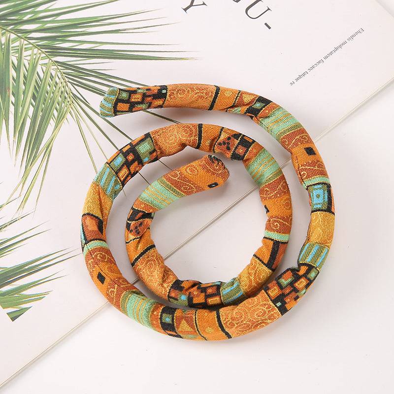 Earth-toned moldable hair tie with a tribal-inspired pattern. Perfect for securing locs, dreadlocks, and braids in a stylish updo.