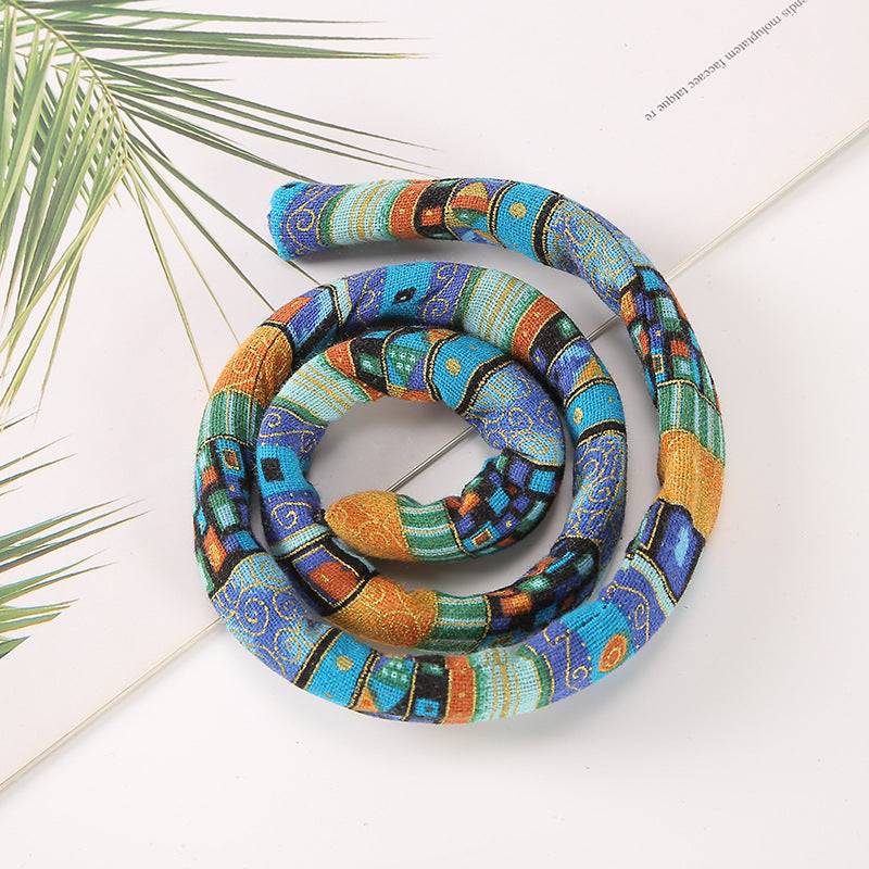 Blue and gold moldable hair tie with a flexible design. Ideal for securing locs, dreadlocks, and braids in stylish updos.