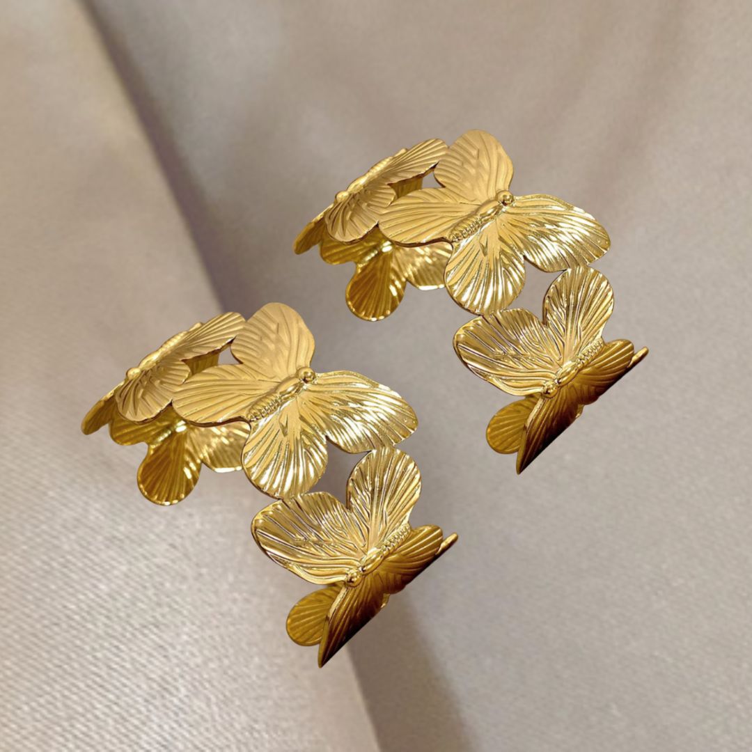 Gold butterflies Cuffs on a beige background