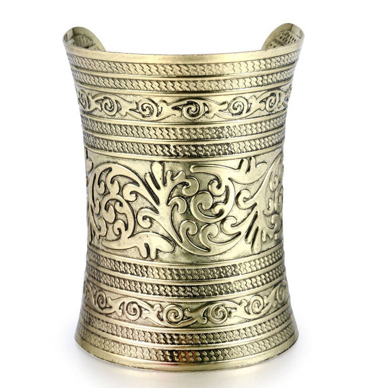 Gold-tone engraved cuff bracelet with intricate detailing. A bold statement piece for natural hair, locs, and braided styles.