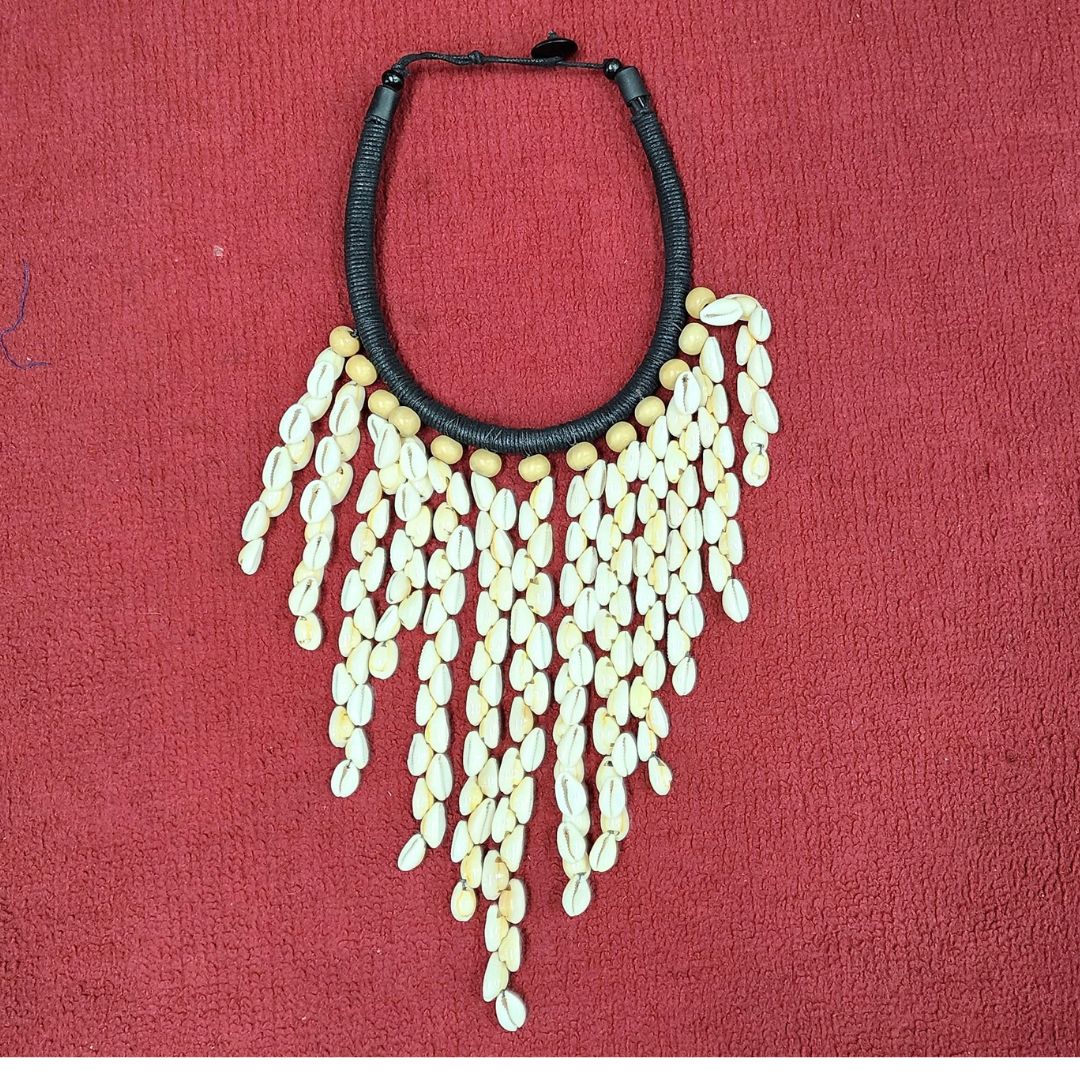 Cowrie Shell Waterfall necklace featuring cascading cowrie shells and wooden beads on a handcrafted black cord. A unique African handmade jewelry piece.