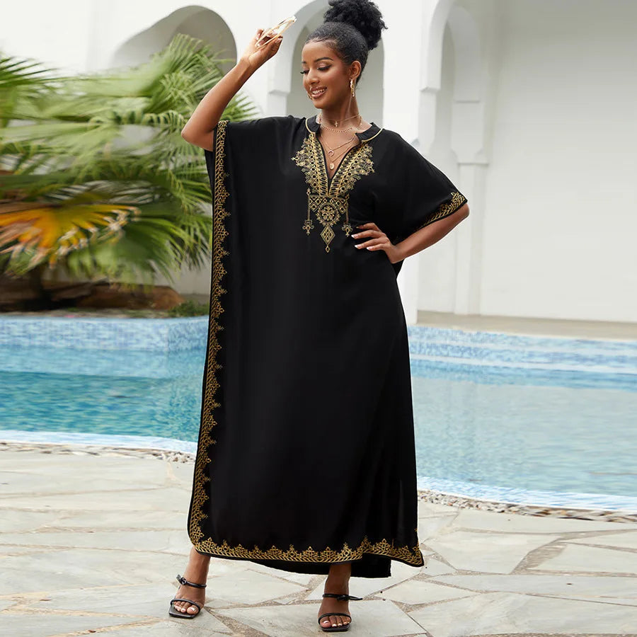 Black embroidered kaftan with gold detailing, a loose-fitting and stylish design, perfect for traditional or evening wear.