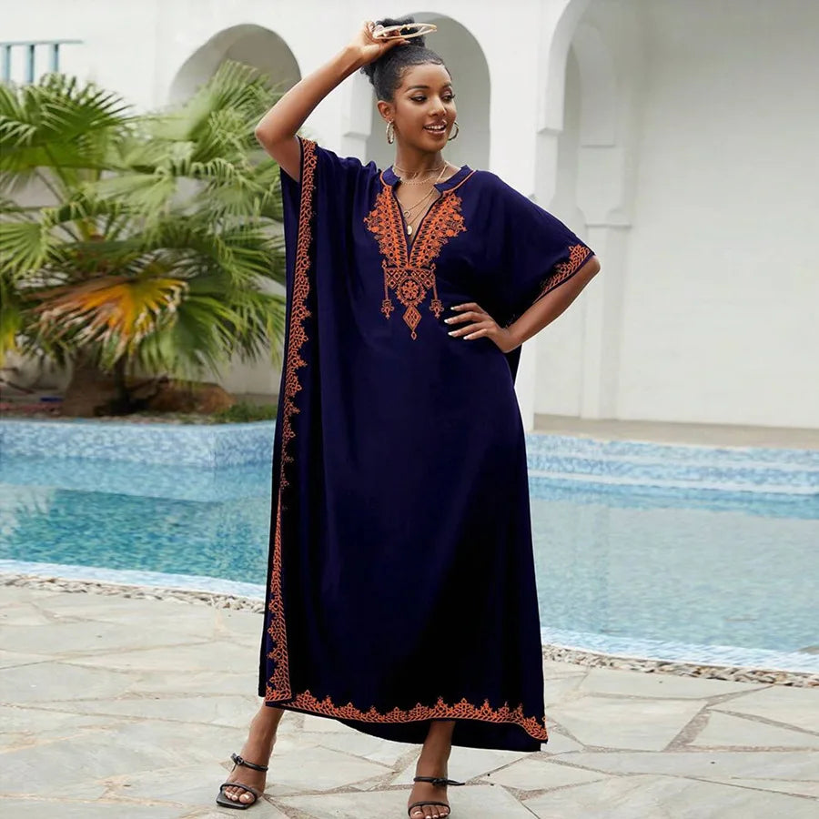Navy blue embroidered kaftan with orange detailing, featuring a V-neck and flowing silhouette, ideal for elegant or casual wear.