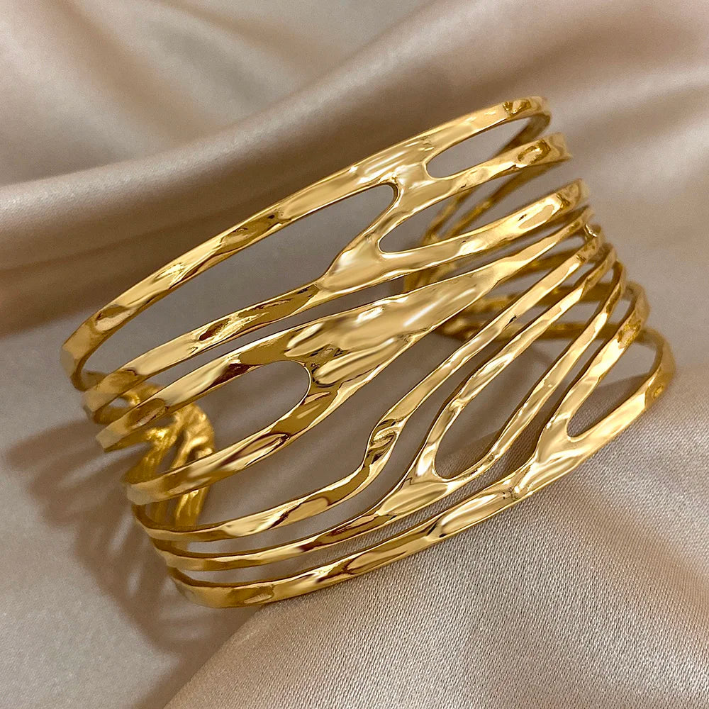 Close-up of Gold Irregular Hair Cuff with fluid hollow design and polished finish