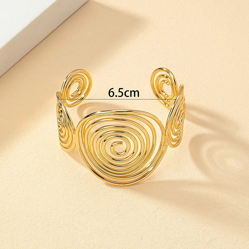 Gold geometric spiral hair cuff with a 6.5 cm width, shown with measurement for reference.