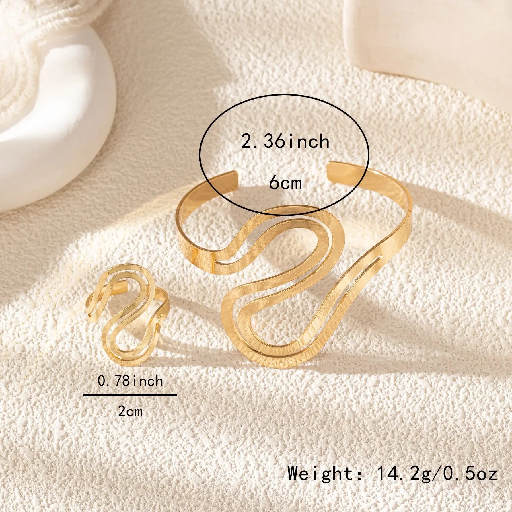Gold snake-inspired bracelet and ring set with size measurements and weight details displayed.