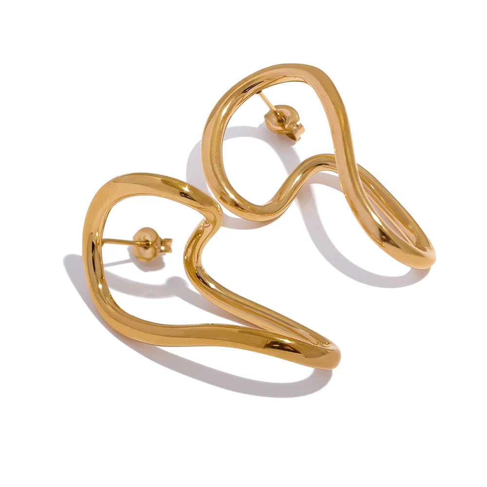 Close-up of gold twisted stud earrings with a wavy abstract design. A stylish and elegant accessory for women.