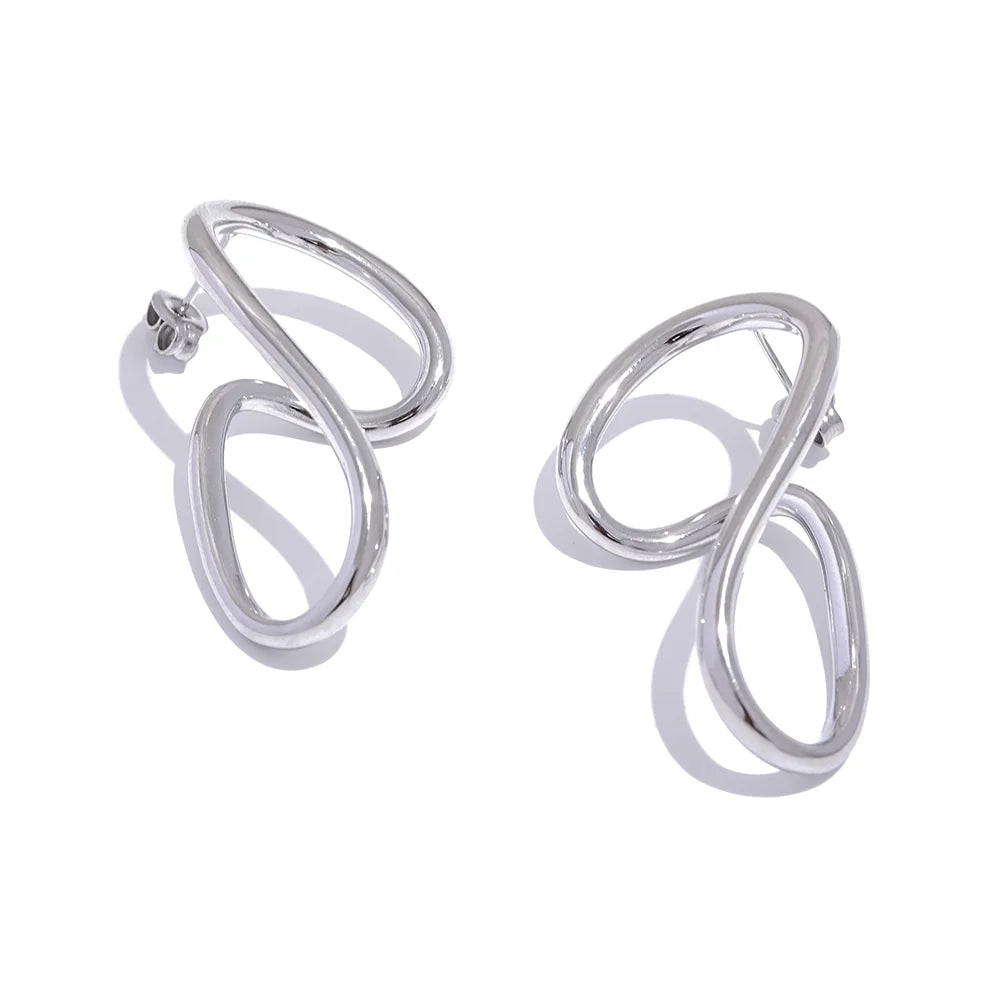 Silver twisted stud earrings with a modern abstract shape. A sleek and contemporary jewelry piece for women.