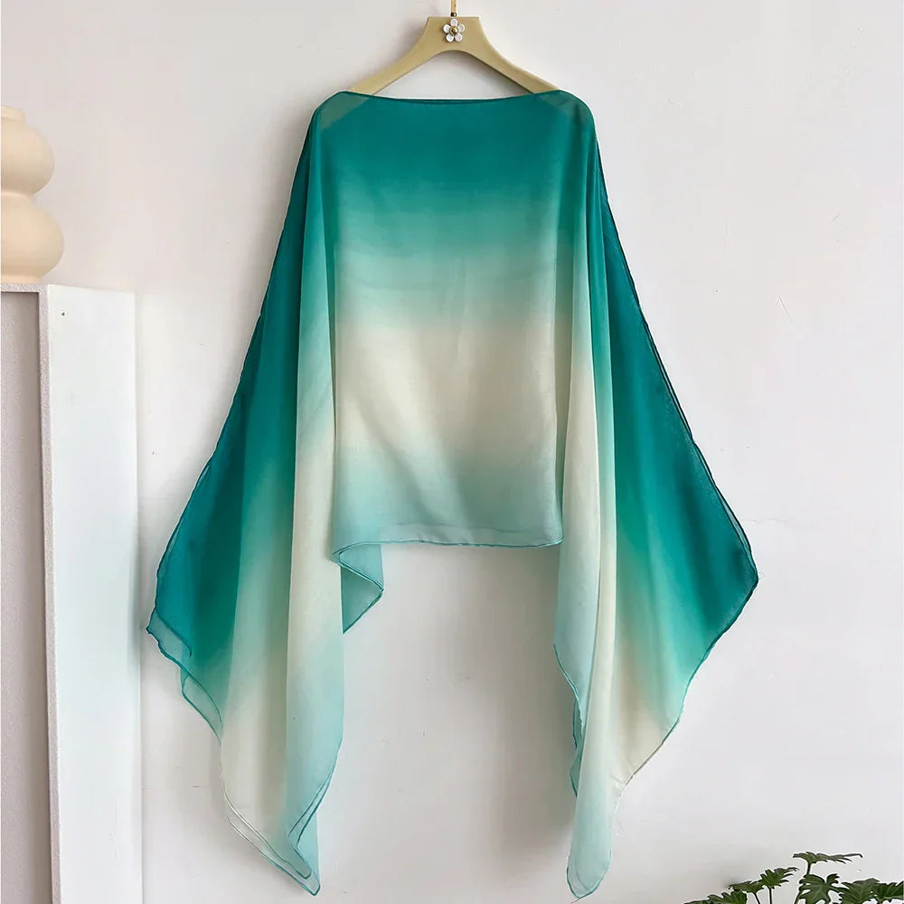 Teal to white gradient sheer shawl with flowing flair sleeves. A lightweight and stylish wrap, perfect for evening or casual wear.