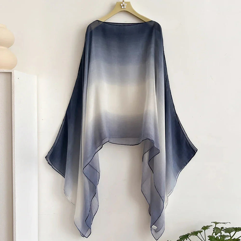 Navy blue to white gradient sheer shawl with elegant flair sleeves. A versatile wrap for layering over casual or formal outfits.
