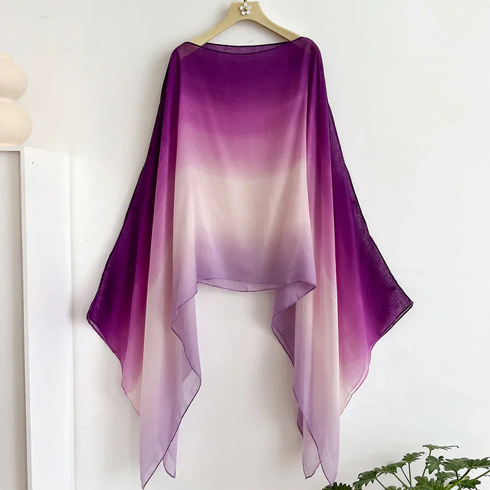 Gradient sheer shawl in purple to white ombre with flair sleeves. A versatile wrap for evening or casual wear, perfect for layering over any outfit.
