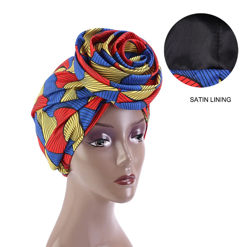 Multicolored Ankara head wrap with satin lining, featuring a bold red, blue, and yellow pattern. Ideal for natural hair care.