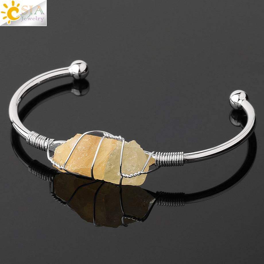 Silver-tone copper bracelet with a wire-wrapped irregular yellow crystal quartz centerpiece.