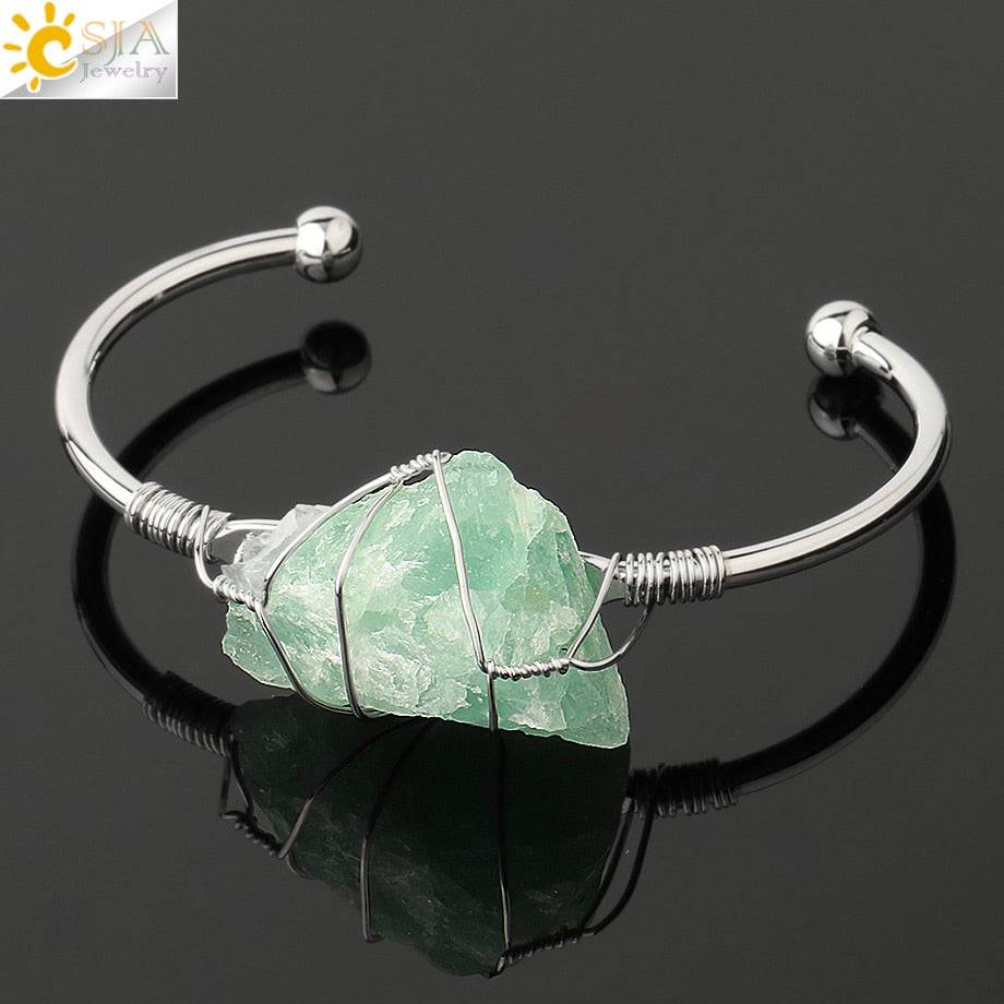 Silver-tone copper bracelet with a wire-wrapped irregular green crystal quartz centerpiece.