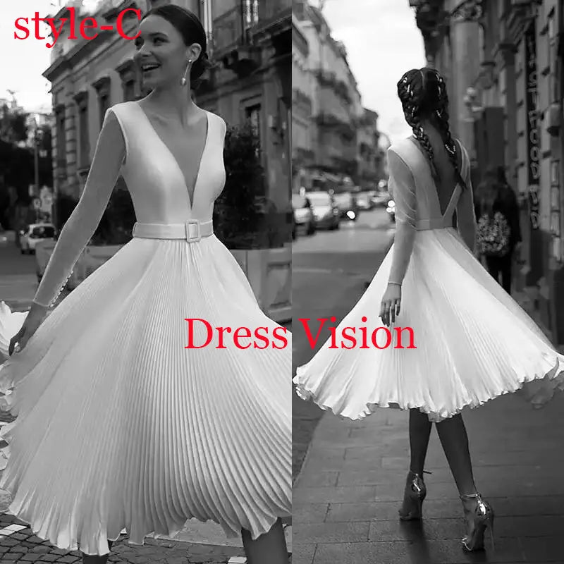 Elegant white pleated midi dress with a deep V-neck and sleeveless design. A sophisticated and timeless wedding dress.