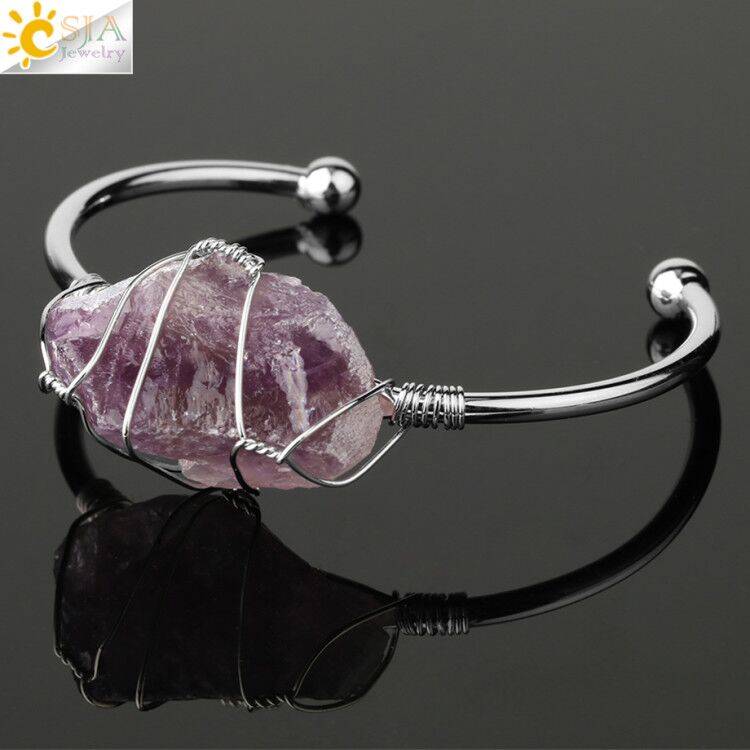 Silver-tone copper bracelet featuring a wire-wrapped irregular amethyst crystal quartz centerpiece.