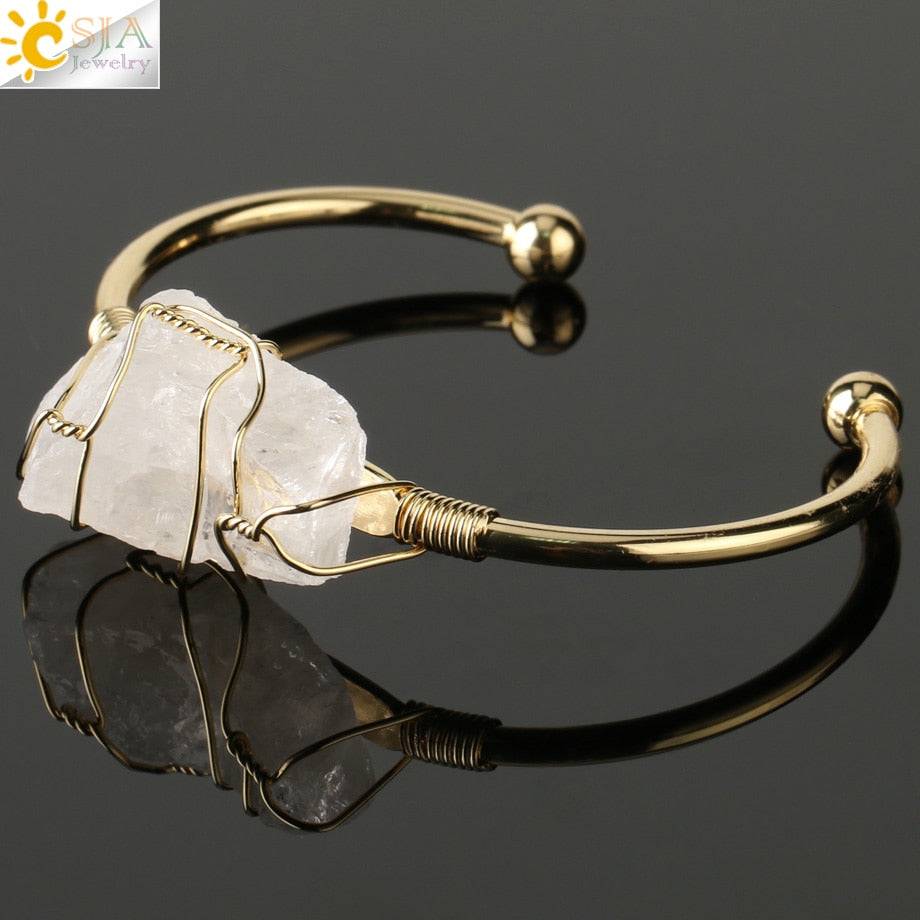 Gold-tone copper bracelet featuring a wire-wrapped irregular white crystal quartz centerpiece.