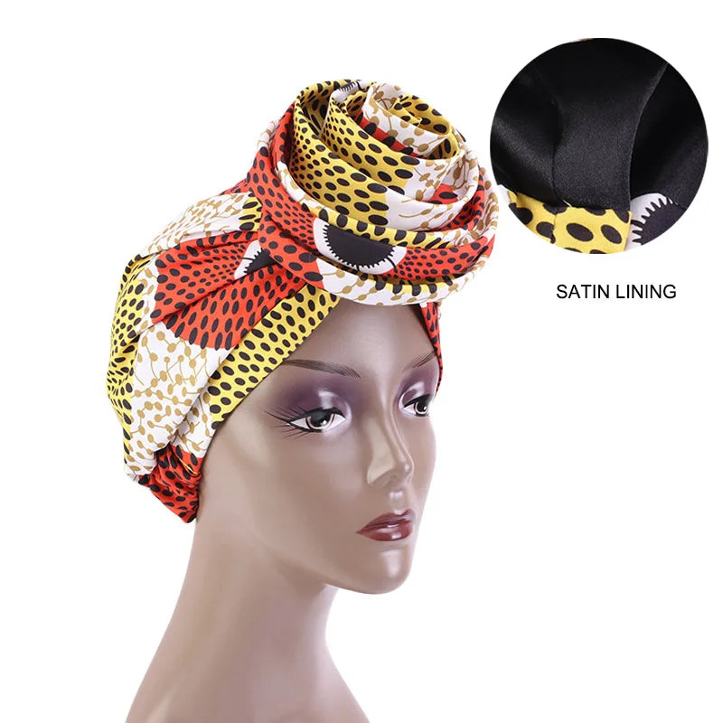White, red, and yellow Ankara head wrap with satin lining, featuring a bold African print. Designed for comfort and elegance.