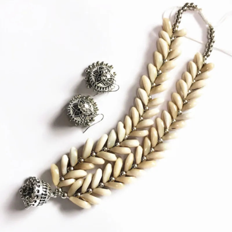 Handmade Cowrie Shell Necklace with matching silver earrings, ideal for special occasions. A symbol of elegance and cultural heritage.