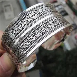 Silver-tone vintage cuff bracelet with delicate filigree engravings, ideal for women seeking a timeless and sophisticated jewelry piece.