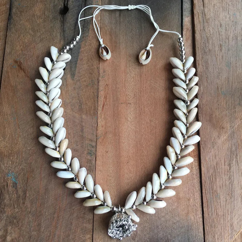 Handmade Cowrie Shell Necklace with silver pendant, elegantly crafted for special occasions. A perfect accessory for weddings and cultural events.