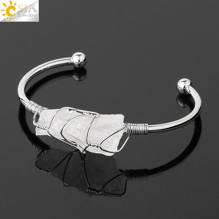 Silver-tone copper bracelet with a wire-wrapped irregular white crystal quartz centerpiece.