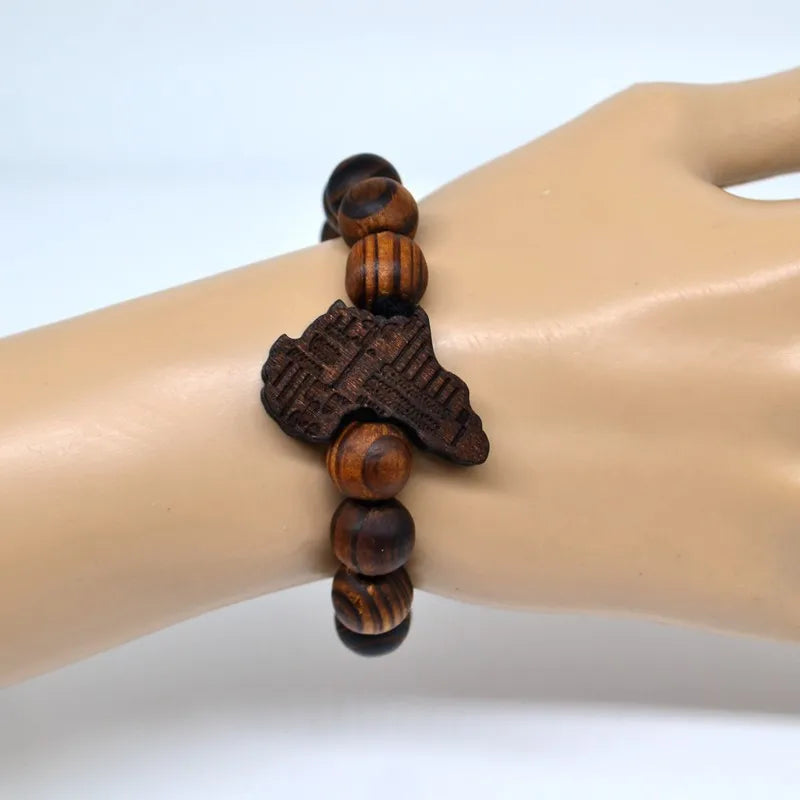 African Roots Wooden Beaded Bracelet worn on a wrist, showcasing its stylish unisex design. Features natural wood beads and an Africa-shaped charm.