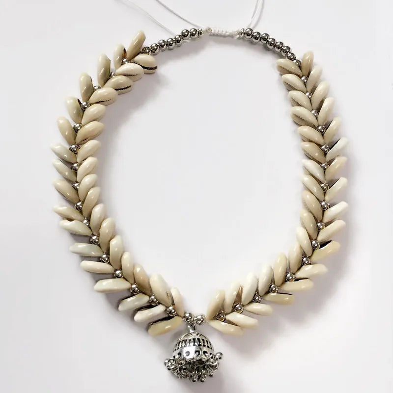 Handmade Cowrie Shell Necklace featuring a silver pendant, meticulously designed for weddings and cultural events. A timeless piece of jewelry.