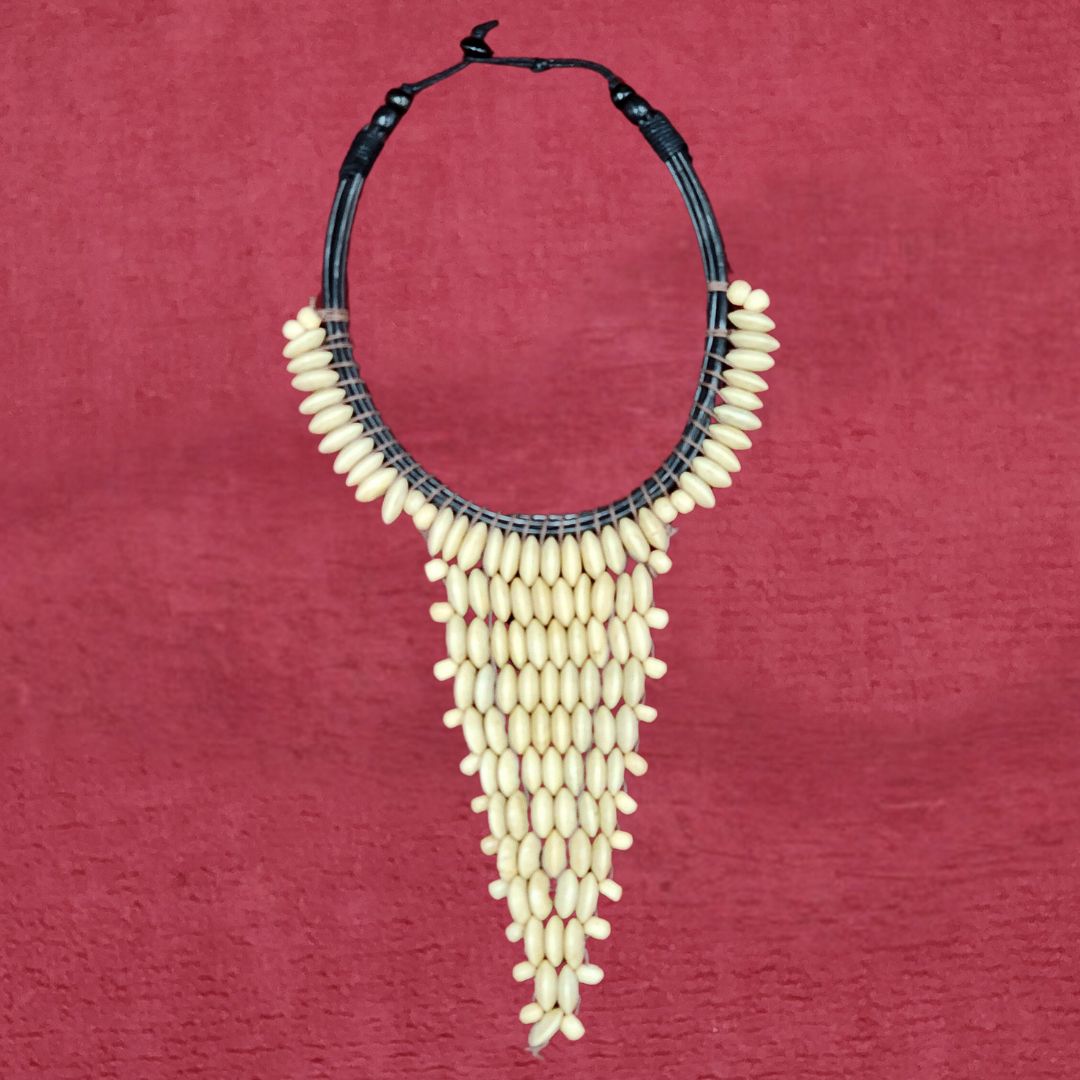Ivory Crescent Bib Necklace featuring handcrafted wooden beads in a cascading design. Elegant African-inspired statement jewelry for any occasion.