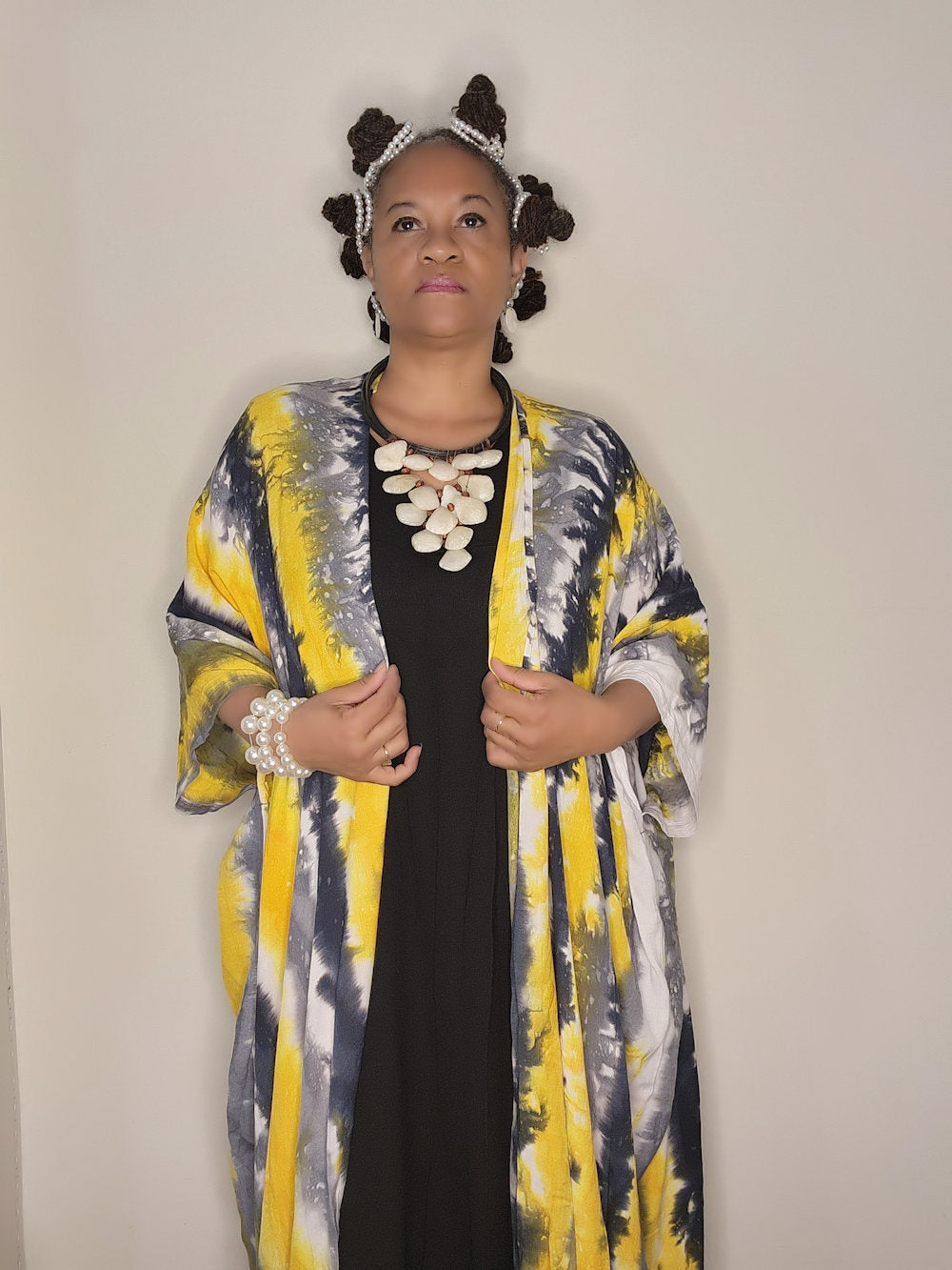 Sophisticated black maxi dress with a hand-dyed yellow and black kimono-style cape. A unique and artistic fashion choice.
