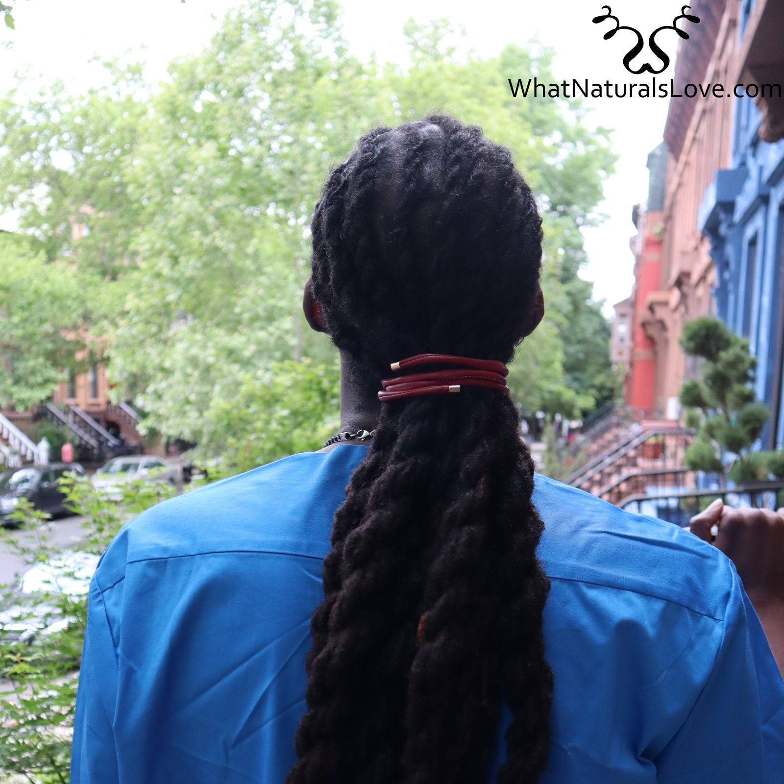 Back view of a man wearing a red ponytail holder for locs. This non-damaging hair tie is perfect for dreadlocks, braids, and sisterlocks.