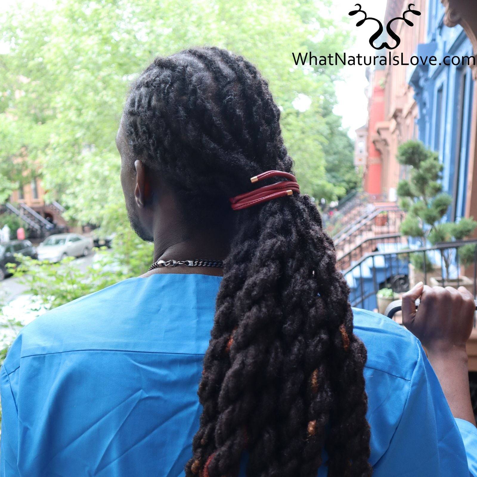 Man with thick dreadlocks secured with a red non-damaging ponytail holder. Ideal hair tie for locs, braids, and sisterlocks, ensuring a secure hold.