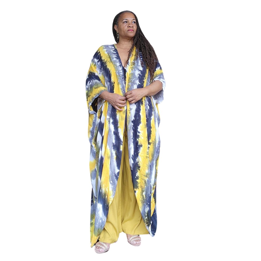Hand-dyed kimono with pockets in vibrant yellow, black, and white hues. Flowing maxi dress style, perfect for spring and summer fashion.