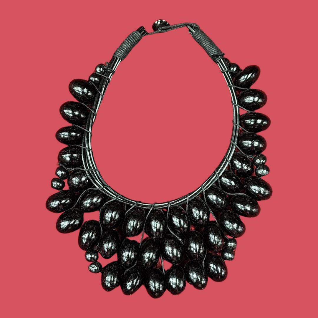 Midnight Crescent Bead Necklace featuring handcrafted wooden beads in a bold crescent design. A statement African necklace for unique styling.