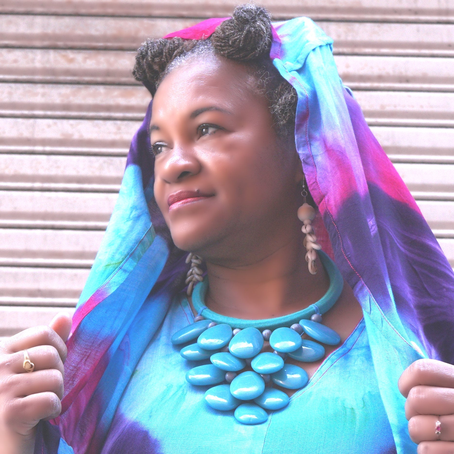 Woman wearing the Turquoise Tide Cluster Necklace, showcasing its vibrant turquoise beads. A striking accessory for elegant and cultural fashion.
