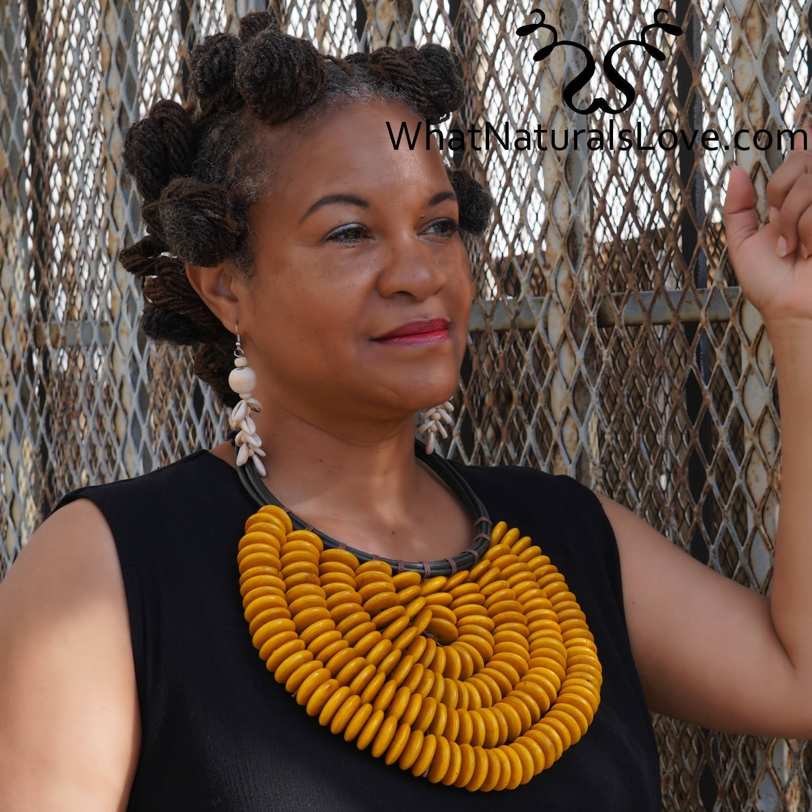 Model wearing Handmade Citrine Cascade Collar, a bold African necklace with yellow wooden beads. A unique statement piece for fashion-forward styling.