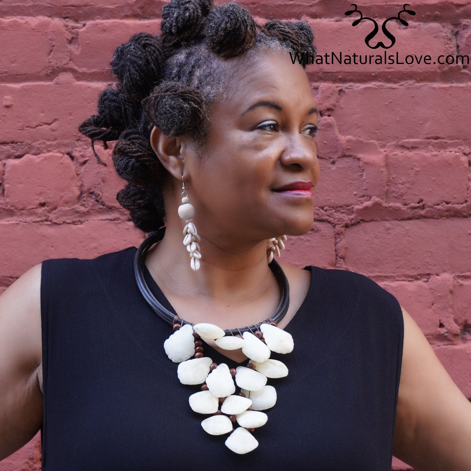Model wearing the Ivory Petal Cascade Choker, a bold handmade necklace with cascading white beads on a black cord. Perfect for stylish, unique looks.