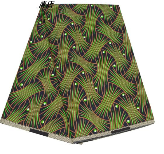 African fabric with green and black wave patterns, ideal for headwraps or clothing. A bold and stylish textile for cultural fashion.
