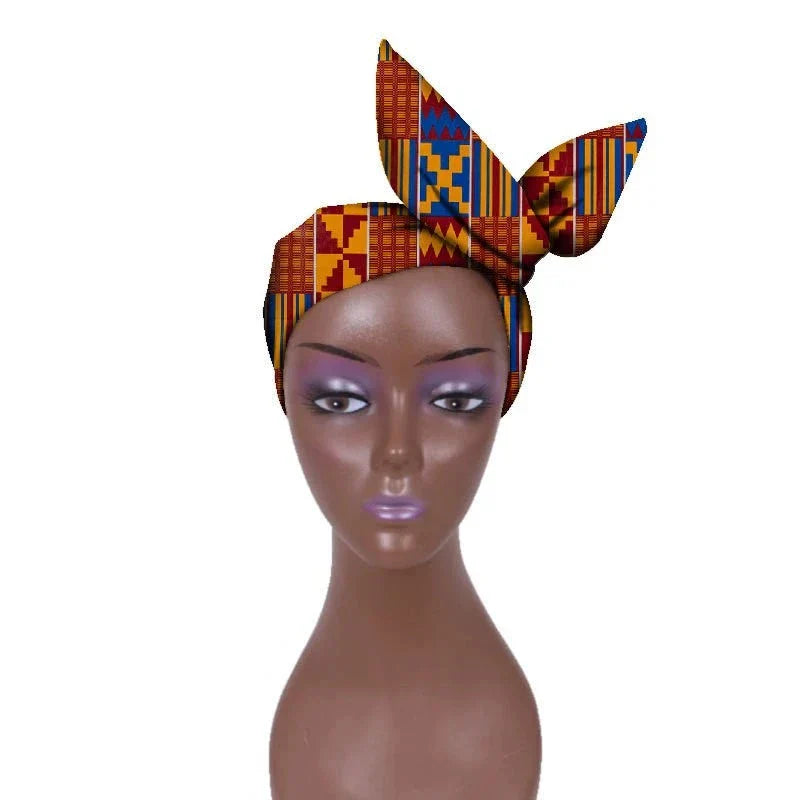 African hair bow band headdress in multicolored Kente patterns, styled on a mannequin. A vibrant and cultural hair accessory.