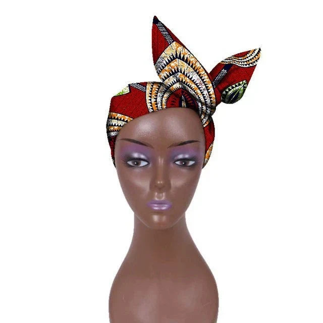 Red African hair bow band headdress with intricate patterns, styled on a mannequin. A fashionable and cultural hair accessory.