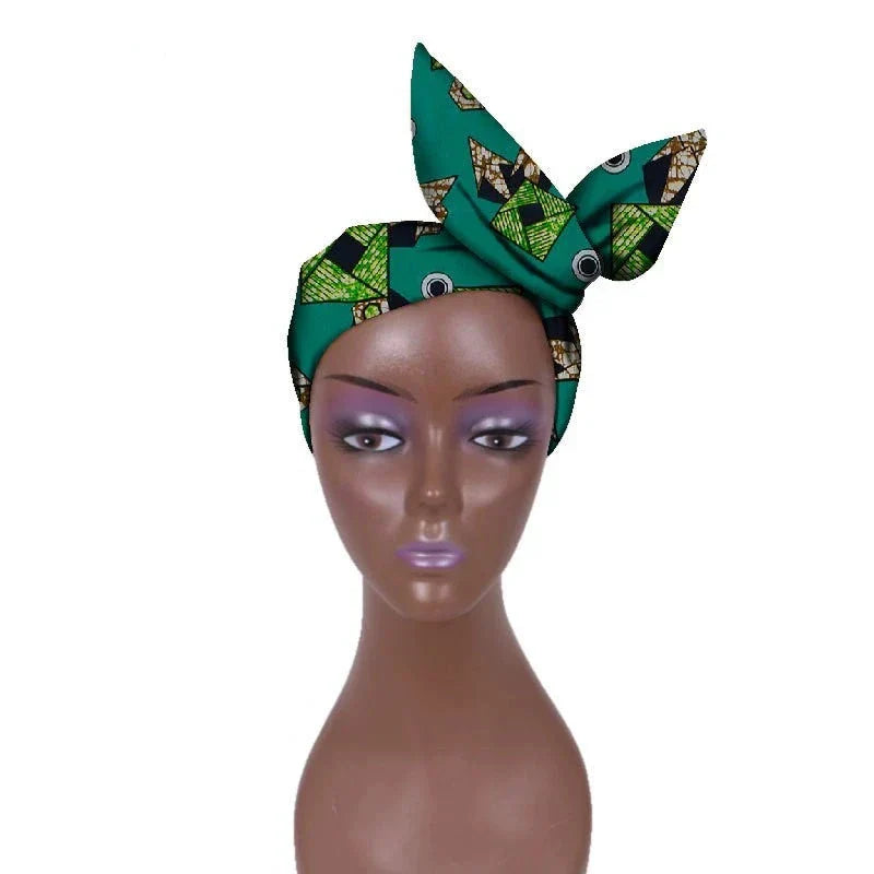 Green African hair bow band headdress with intricate patterns, displayed on a mannequin. A stylish and elegant headwrap for various looks.