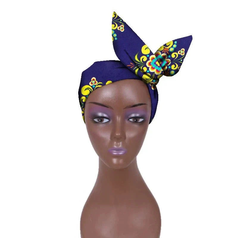 African hair bow band headdress in navy blue with floral patterns, displayed on a mannequin. Elegant headwrap for traditional and modern styles.