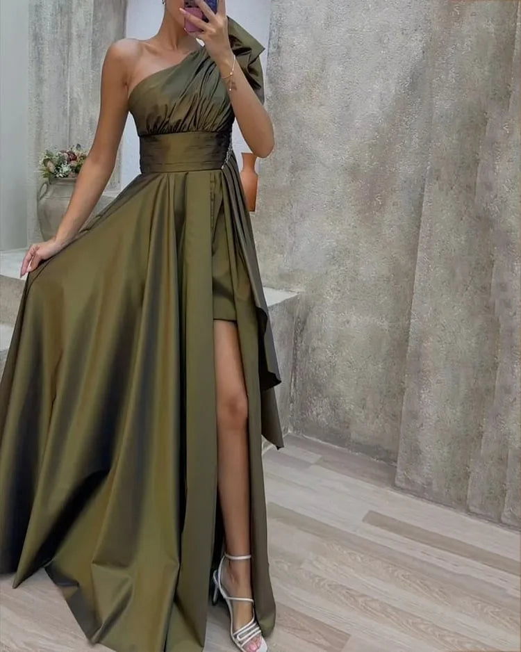 Satin one-shoulder maxi dress in olive green with an A-line silhouette and side slit. Elegant evening gown perfect for formal events and parties.
