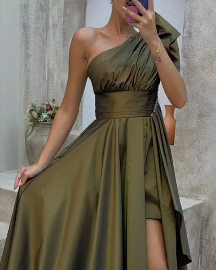 Detailed view of an olive green satin one-shoulder evening gown with ruched bodice and side slit. A chic and modern dress for special occasions.