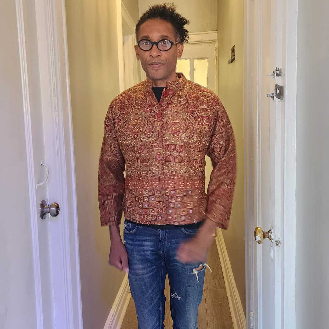 Stylish paisley embroidered Indian jacket with intricate detailing, worn over distressed jeans. A breathable and lightweight choice for any occasion.