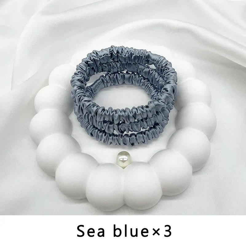 Three sea blue mulberry silk elastic hair bands. Soft, frizz-free ponytail holders for natural hair and protective styles.
