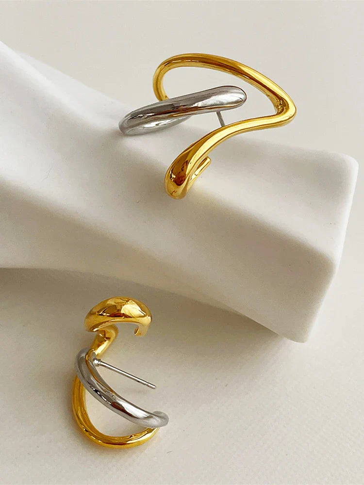 Two-tone silver and gold heart earrings with a unique abstract swirl design. A perfect blend of modern and vintage aesthetics for women.