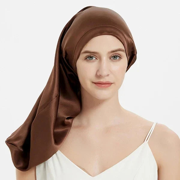 Chocolate brown Mulberry Silk Sleep Bonnet for long hair, worn by woman. Smooth silk headwrap for frizz protection and comfort.