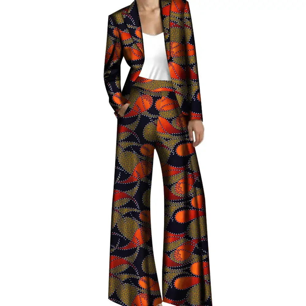 Chic African pantsuit with an orange and navy abstract pattern. Features a tailored jacket and wide-leg trousers, made from breathable cotton.